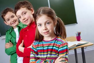 Three students posing in a classroom Three students posing in a classroom
